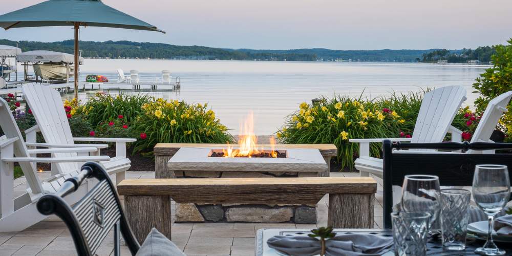 outdoor firepit near lake with seating