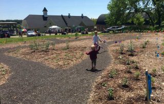 Children using the gravel path in the future pollinator garden
