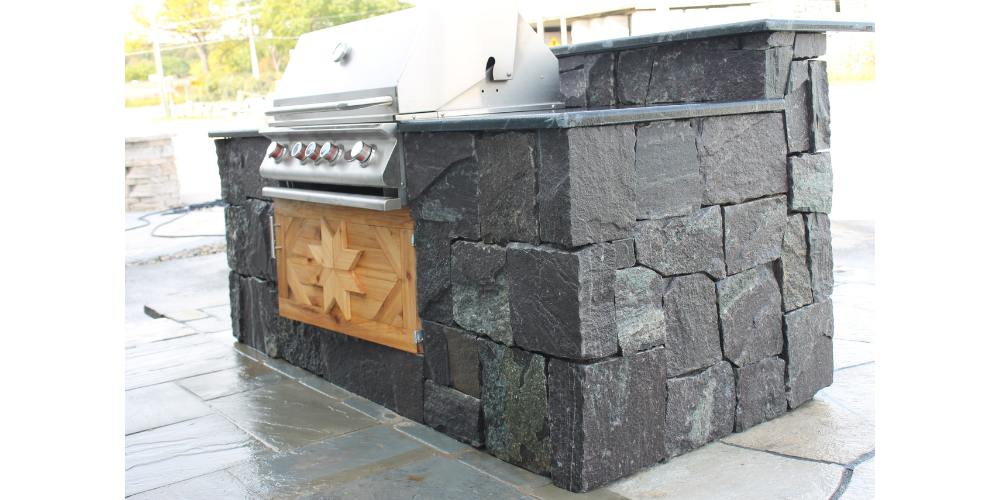 outdoor kitchen with grill enclosure and countertops