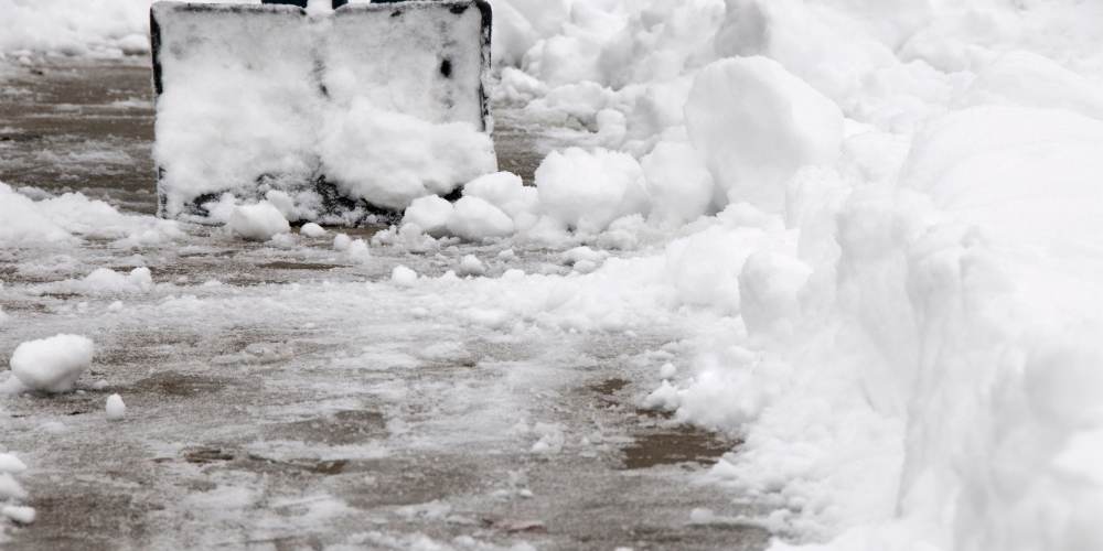 shovel removing snow on sidewalk