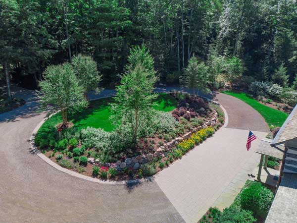 circular driveway with driveway paver pad near home entrance