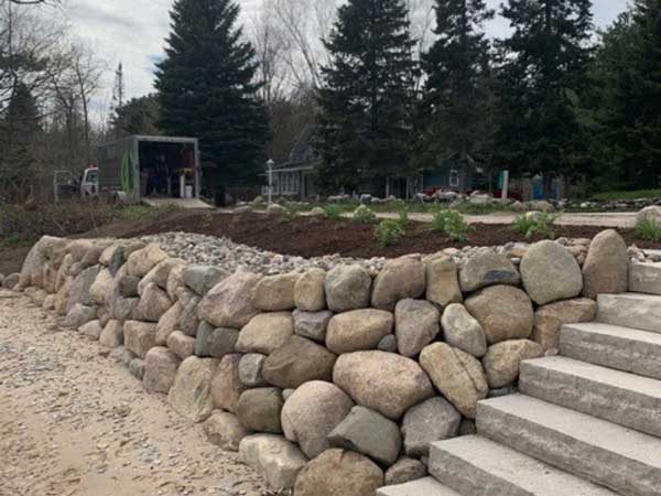 completed shoreline restoration projects with boulders steps and native plantings