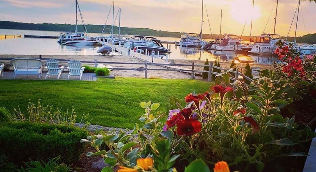 annual plantings surrounding deck overlooking a marina 