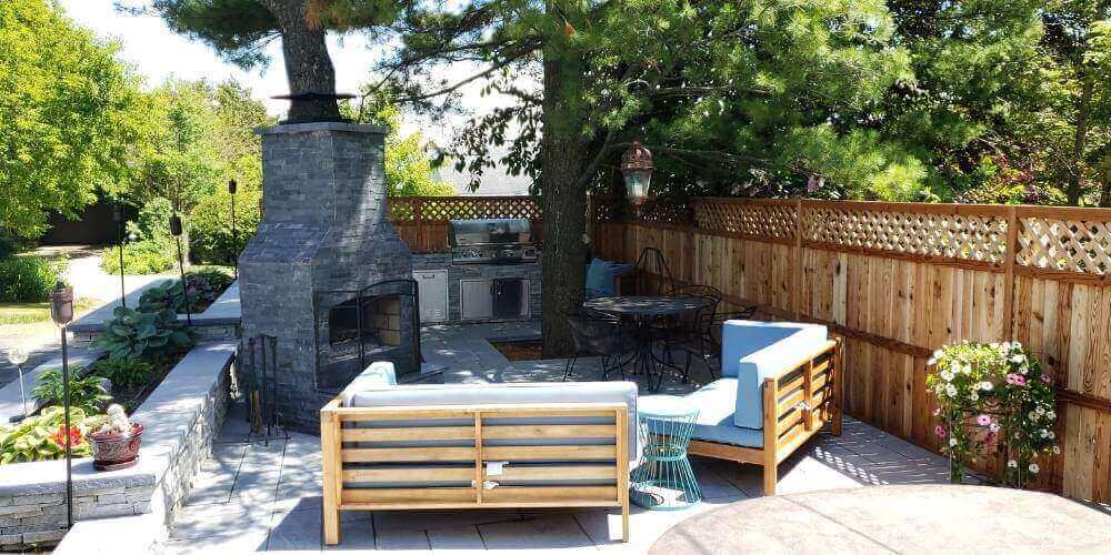 small backyard with pavers firepit and outdoor kitchen