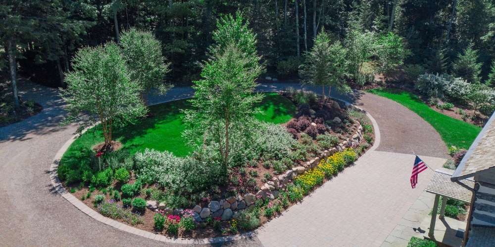 aerial photo of island planted with trees and perennial plantings