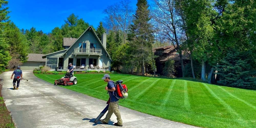 lawn maintenance crew mows and blows turf