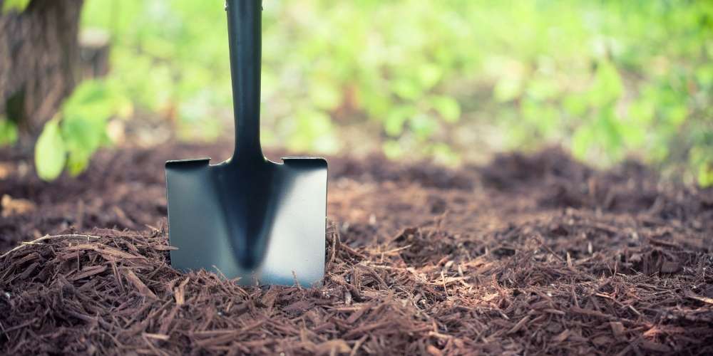 mulch in pile with shovel