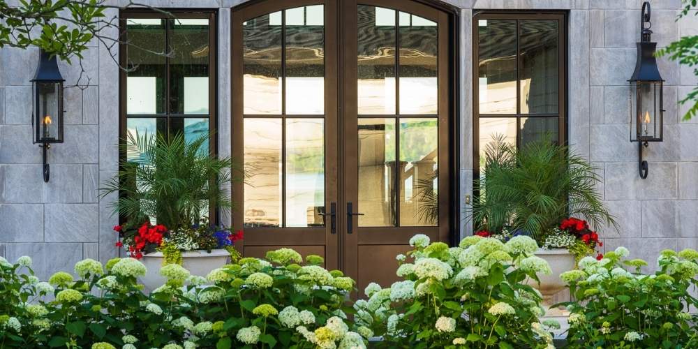 container gardens near entrance with hydrangea