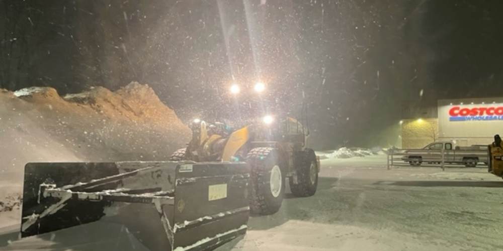 cat 350 loader in front of costco plowing snow