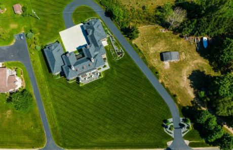 aerial photo of green healthy grass and landscape near large home