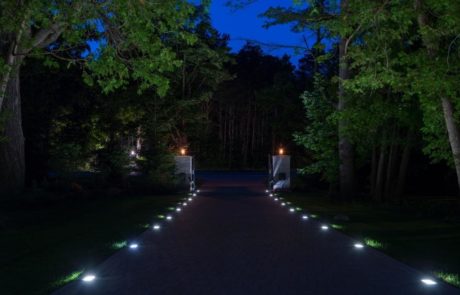 driveway at night with landscape lighting
