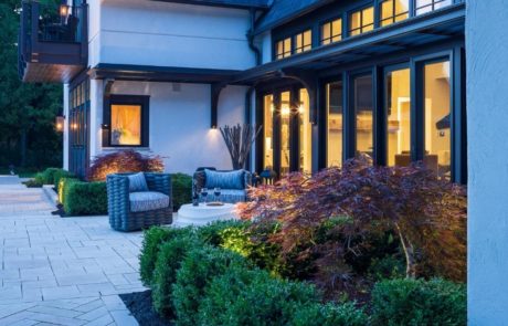 Japanese maple and boxwood near limestone patio with seating