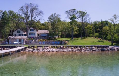 view of home and landscaping from dock in lake