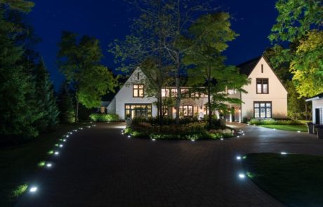 front of home at night with landscape lighting