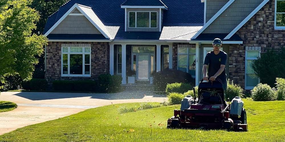 lawn maintenance team mows lawn at home