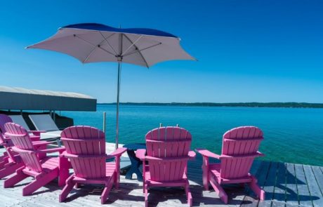 pink chairs on dock overlook lake