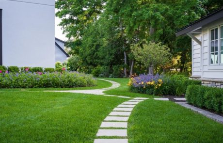 limestone stepper pathway with green grass and plantings