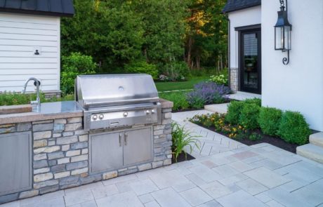 built in grill in outdoor kitchen on limestone patio