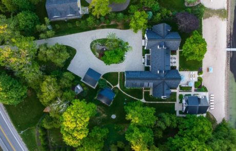 aerial photo of home with large paver driveway