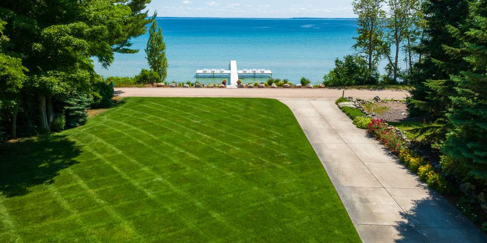 aerial photo of freshly mowed green grass overlooking water