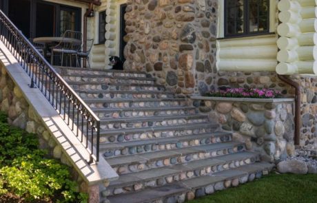 stone steps with annual plantings in container gardens