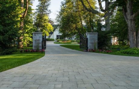 unilock paver driveway with pillars and gate