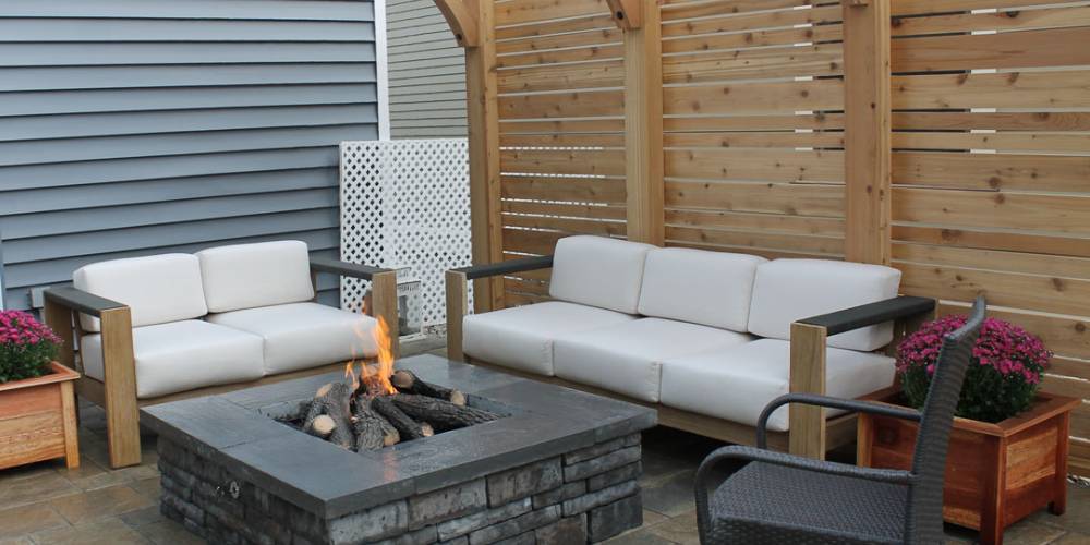 square firepit near pergola and outdoor furniture