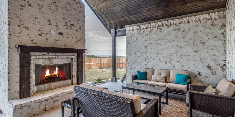 fireplace under pergola with seating
