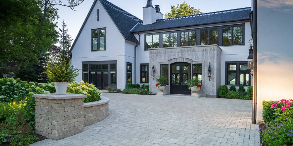 paver driveway and retaining wall with plantings