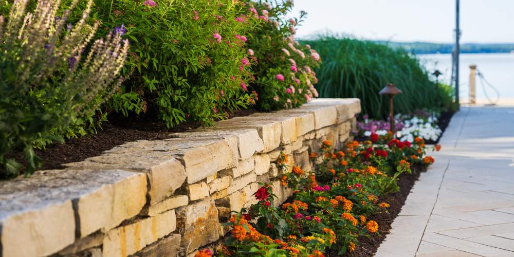 annual flowers planted along paver walkway