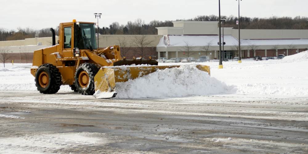 front loader pushes snow