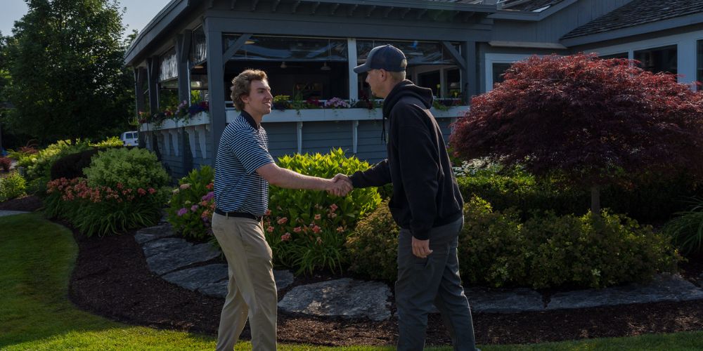 landscape professional shakes hand with client