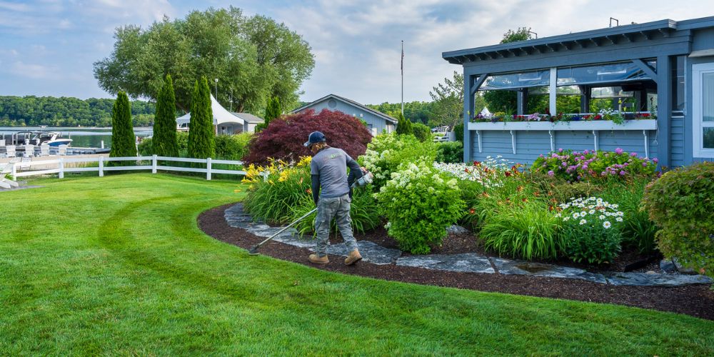landscape professional edges lawn near landscape bed at commercial property