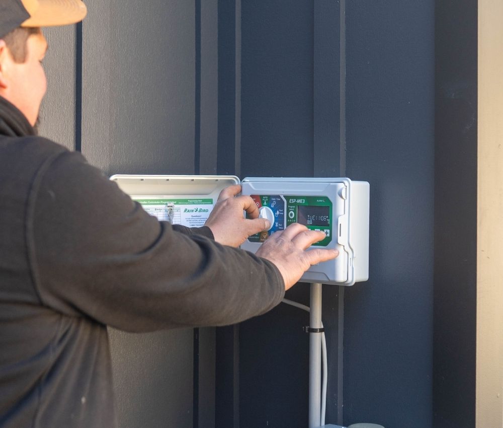 smart-irrigation-controller-wifi-timer modern wifi-connected smart irrigation controller mounted on a wall for automated watering schedules